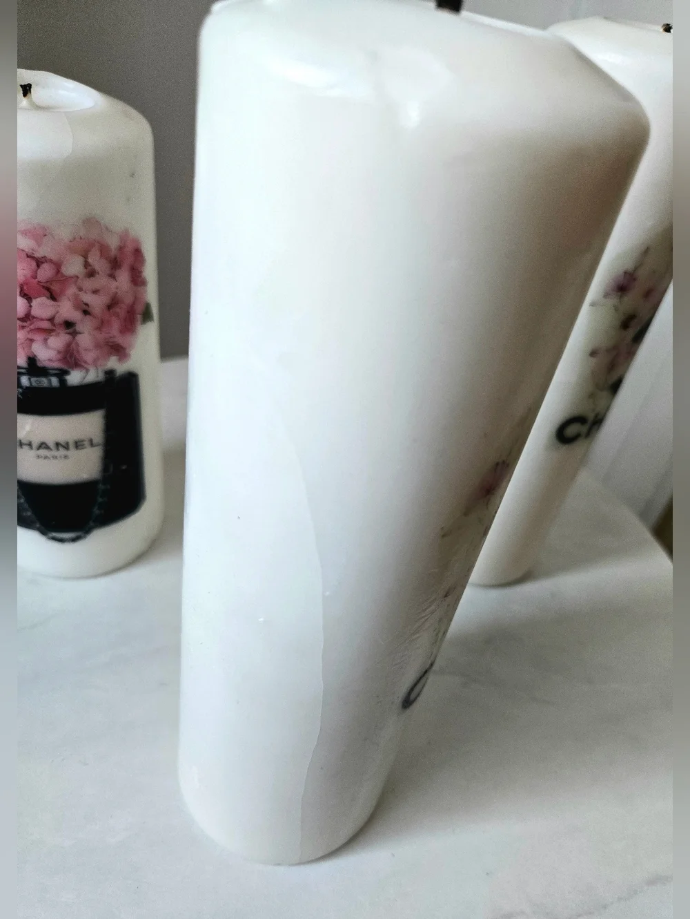 White Pillar Candles with Pink Floral Motif and Black Logo